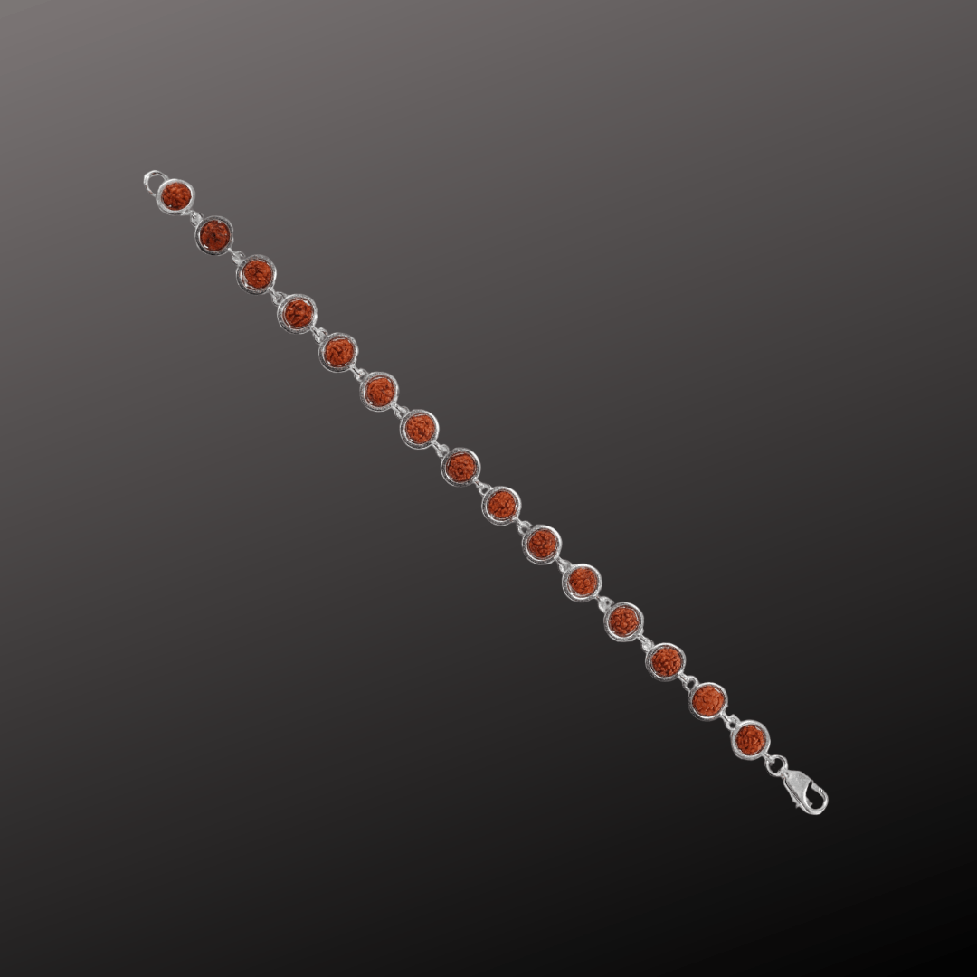 Silver bracelet with red gemstones on a dark gray background
